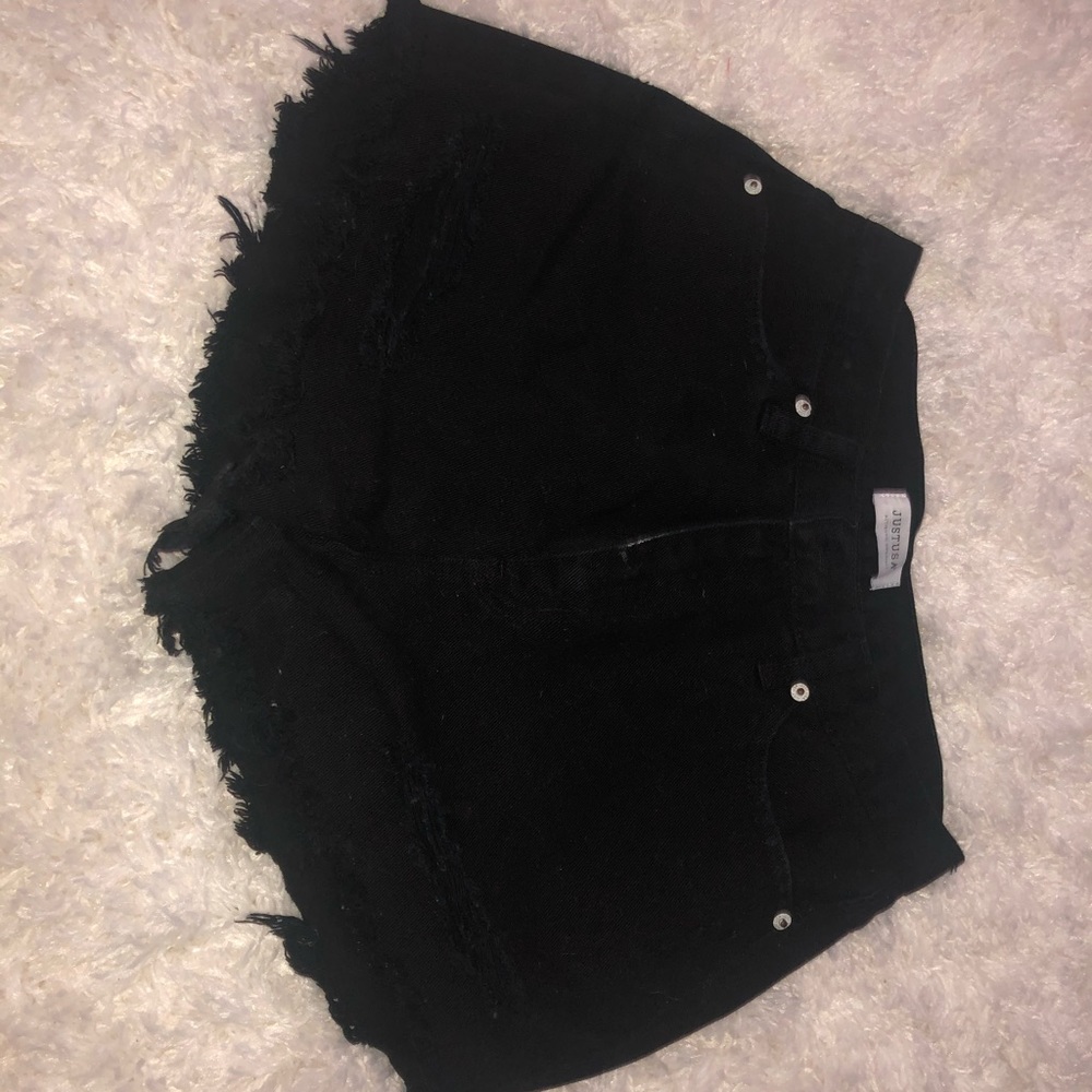 Distressed high rise black shorts.